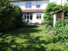 Garden showing old garage taking up a third of the width.